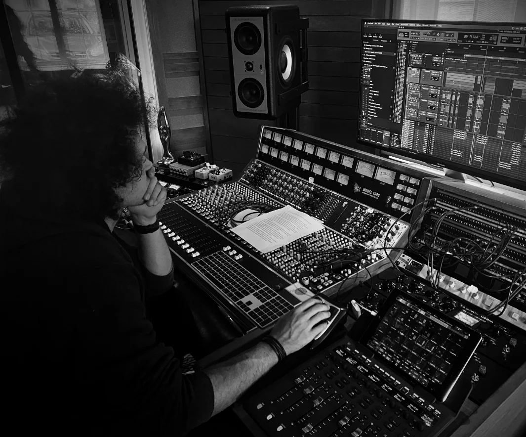 Julien working at a recording studio mixing console